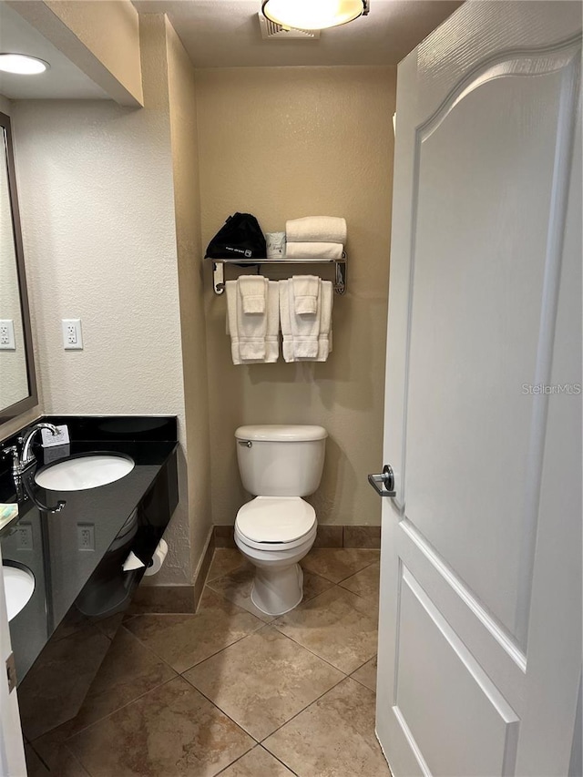 bathroom with visible vents, toilet, tile patterned flooring, baseboards, and vanity