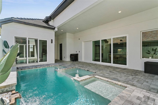 view of pool featuring a patio area and a pool with connected hot tub