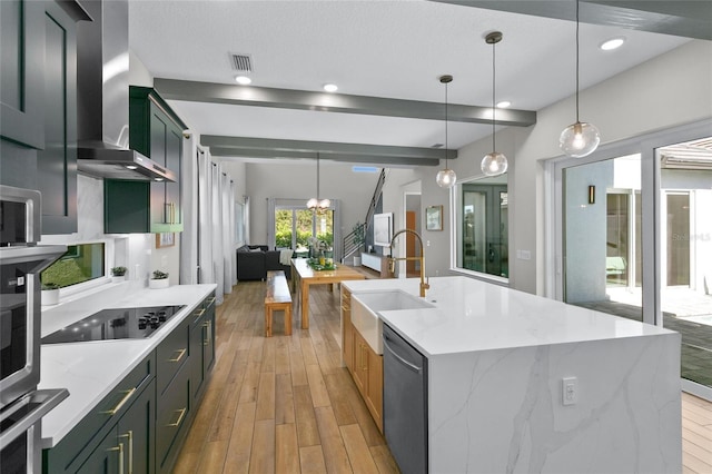 kitchen with a sink, black electric stovetop, wall chimney range hood, light wood-style flooring, and stainless steel dishwasher