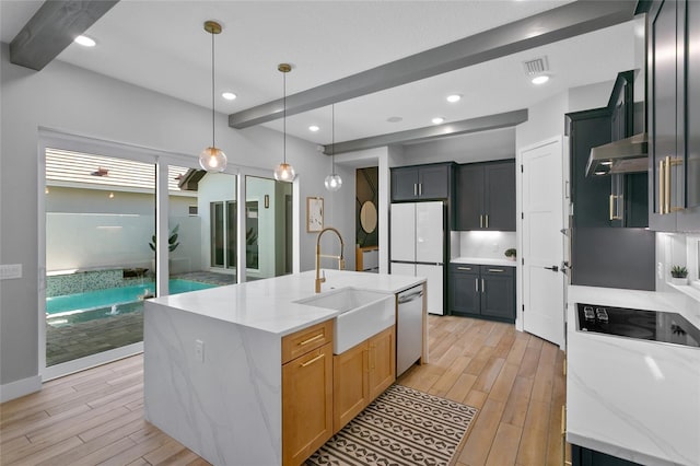 kitchen featuring wood finish floors, beam ceiling, a sink, under cabinet range hood, and stainless steel dishwasher