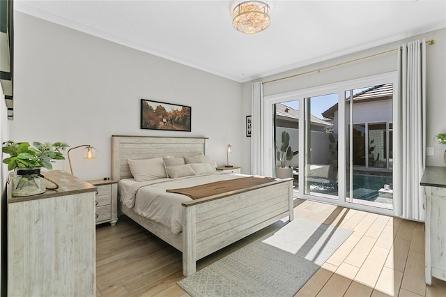 bedroom featuring access to exterior and light wood-type flooring