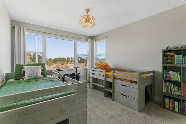 bedroom featuring a textured ceiling and carpet floors