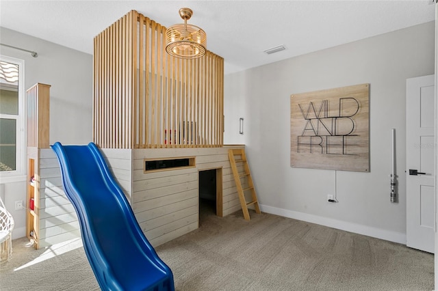 interior space with carpet flooring, baseboards, and visible vents