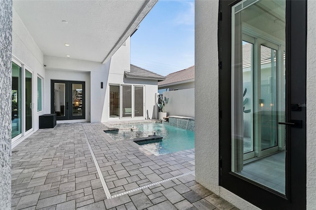 outdoor pool featuring french doors and a patio