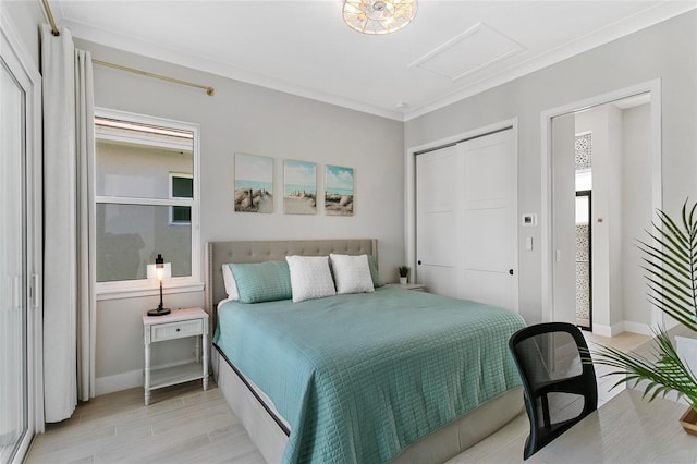 bedroom with ornamental molding, a closet, light wood-style floors, baseboards, and attic access