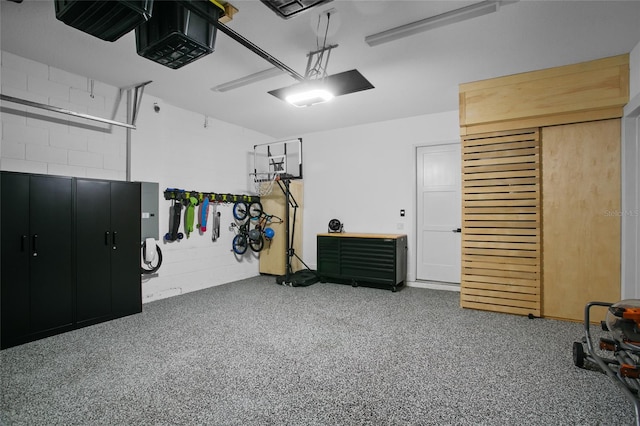 interior space featuring a garage and concrete block wall