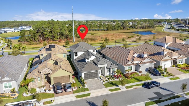 birds eye view of property featuring a residential view and a water view