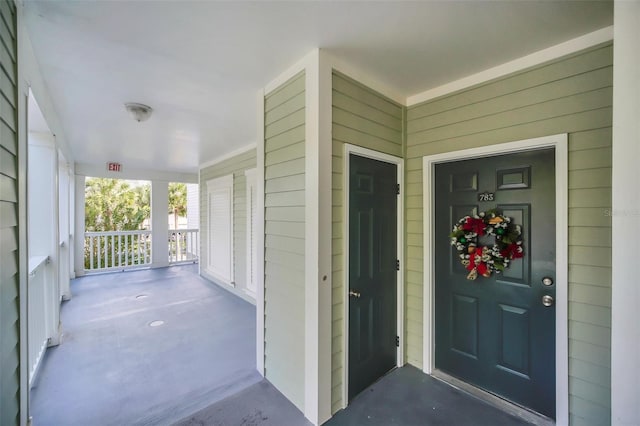 doorway to property featuring covered porch