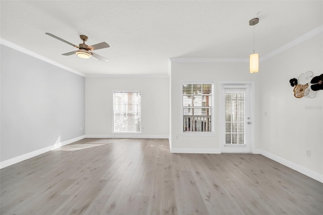 unfurnished room featuring light wood-type flooring, ceiling fan, and crown molding