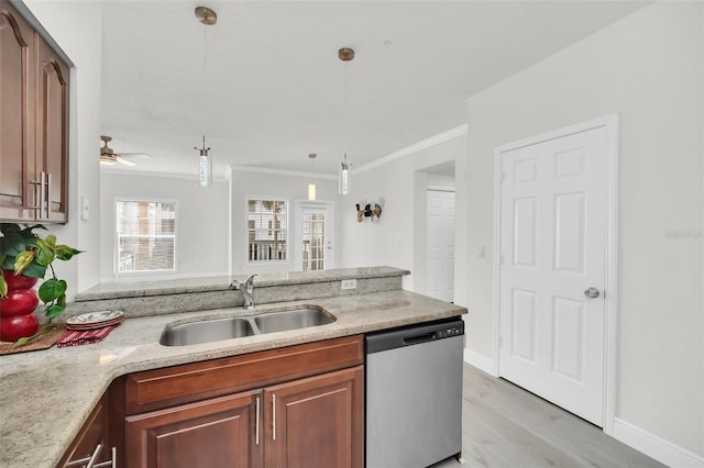 kitchen with ornamental molding, a sink, stainless steel dishwasher, light stone countertops, and hanging light fixtures