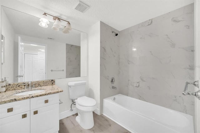 bathroom featuring visible vents, tub / shower combination, baseboards, toilet, and vanity