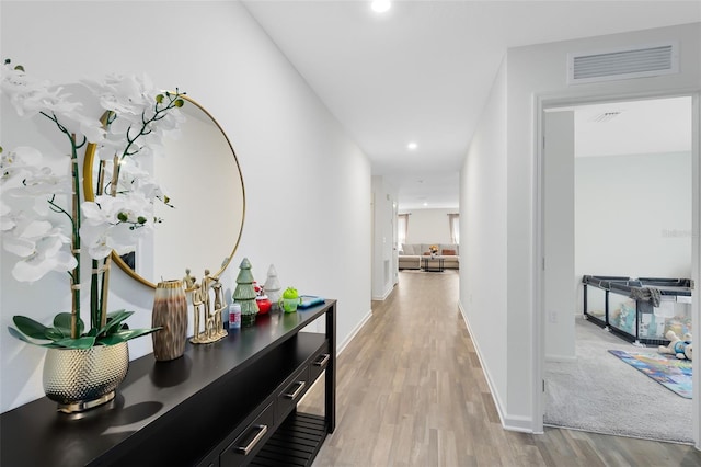 hall featuring visible vents, recessed lighting, light wood-type flooring, and baseboards