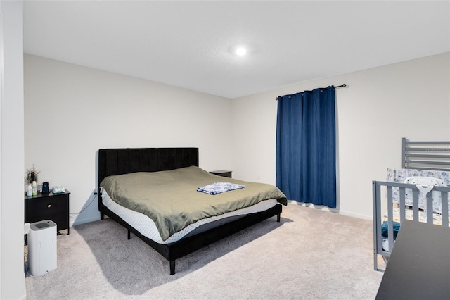 carpeted bedroom featuring baseboards