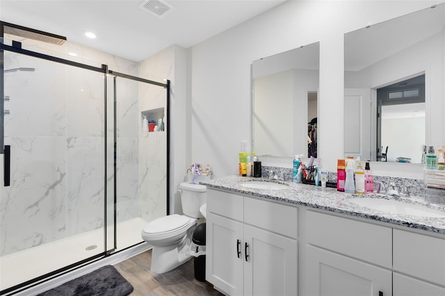 bathroom with visible vents, a marble finish shower, and a sink