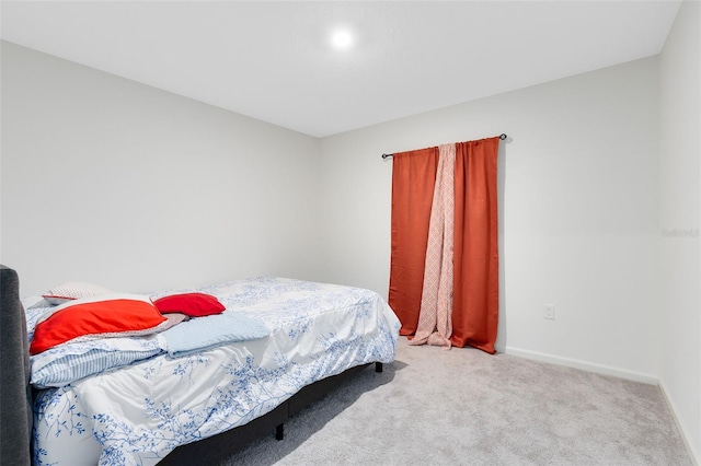 bedroom with carpet and baseboards