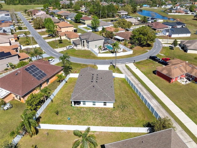 drone / aerial view featuring a water view and a residential view