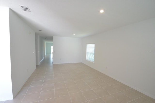 spare room featuring light tile patterned flooring, recessed lighting, and visible vents