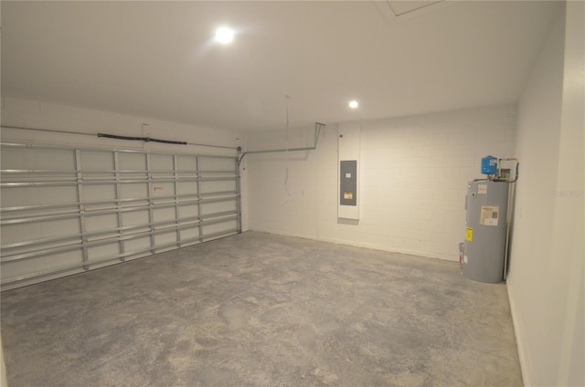 garage with electric panel, electric water heater, and concrete block wall