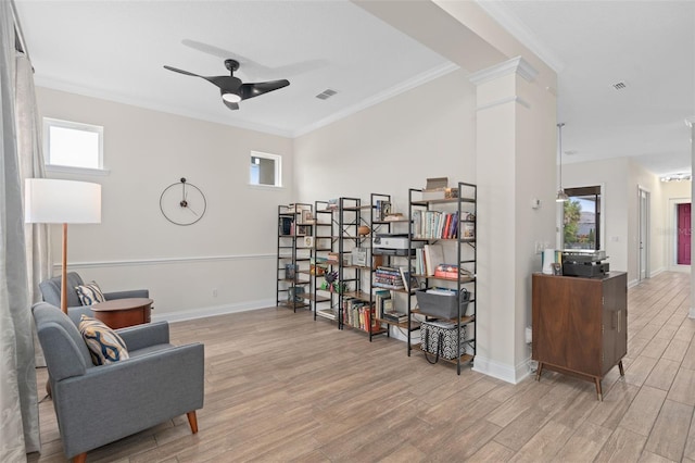 sitting room featuring light wood finished floors, visible vents, decorative columns, plenty of natural light, and a ceiling fan