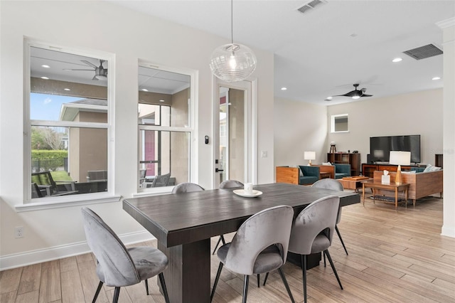 dining room with light wood-style flooring, visible vents, and ceiling fan