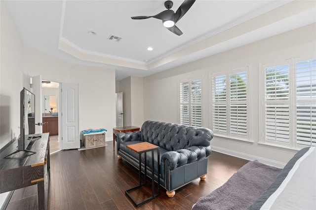 living area with dark wood-style floors, visible vents, baseboards, crown molding, and a raised ceiling