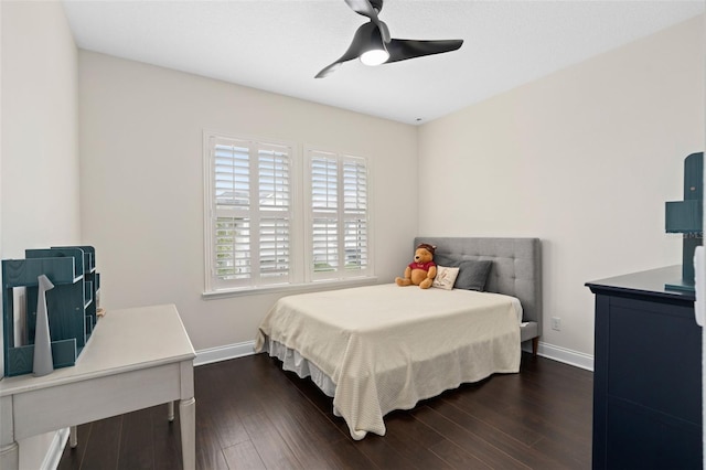 bedroom with a ceiling fan, dark wood-style floors, and baseboards