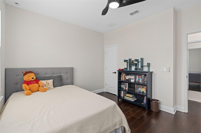 bedroom featuring visible vents, baseboards, wood finished floors, and a ceiling fan