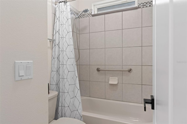 full bath featuring toilet and shower / bath combo with shower curtain