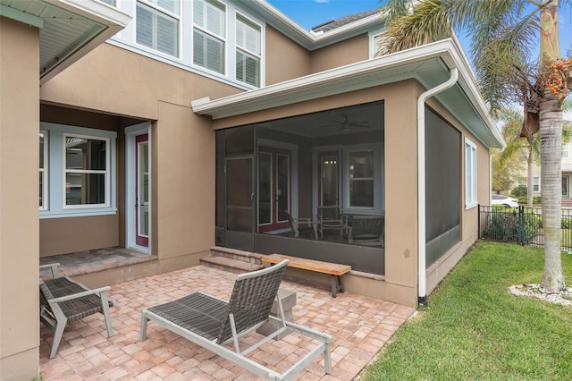 view of patio featuring a sunroom and fence