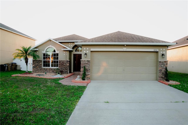 view of front of property with a front yard, driveway, stucco siding, a garage, and stone siding