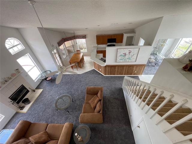 carpeted living room featuring a textured ceiling