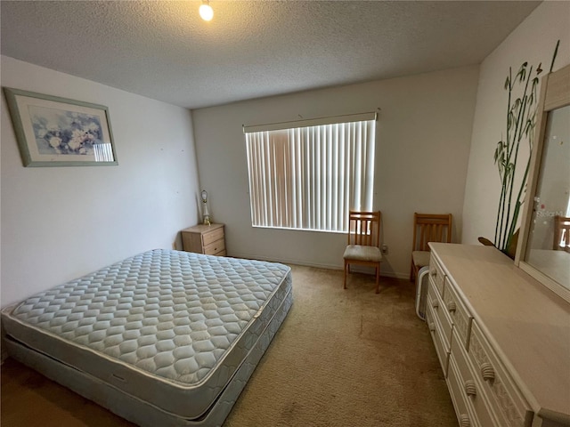 bedroom featuring a textured ceiling and carpet floors