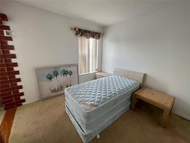 bedroom with carpet floors and a textured ceiling