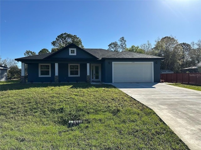 view of front of home featuring fence, french doors, concrete driveway, an attached garage, and a front yard