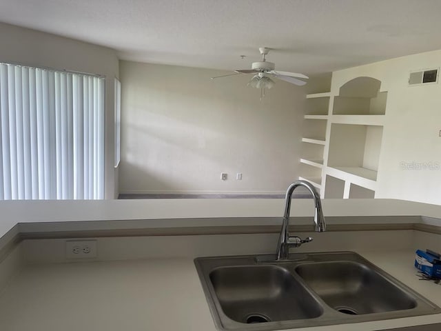 kitchen featuring a sink, visible vents, and a ceiling fan