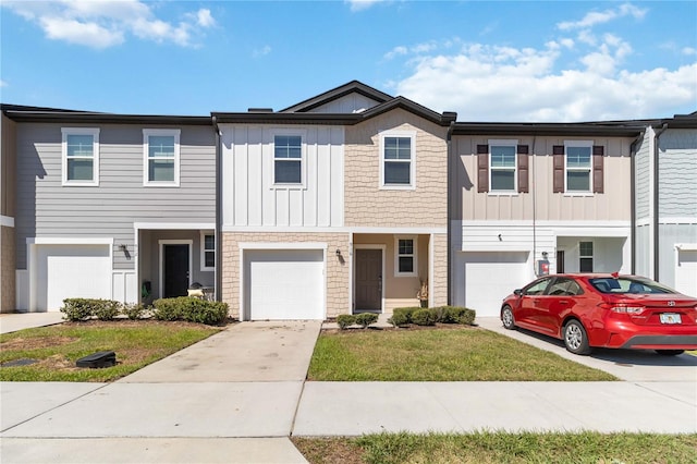 townhome / multi-family property featuring concrete driveway, an attached garage, and board and batten siding