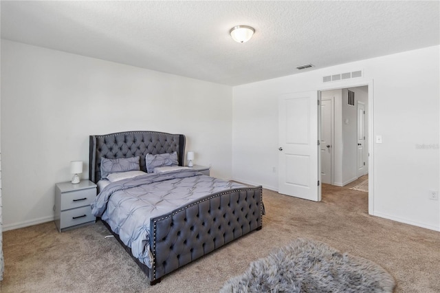 bedroom featuring baseboards, visible vents, carpet floors, and a textured ceiling