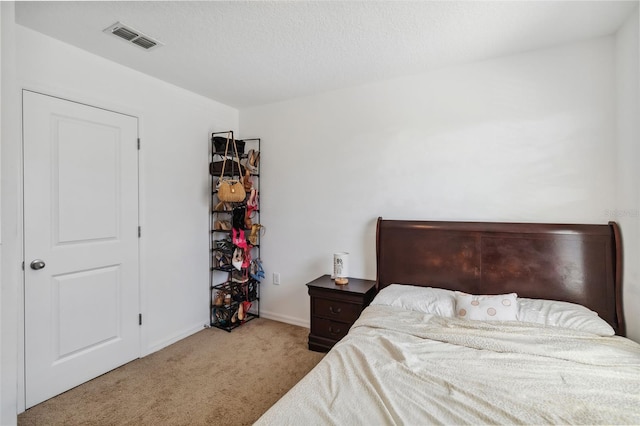 bedroom with visible vents, baseboards, and carpet flooring