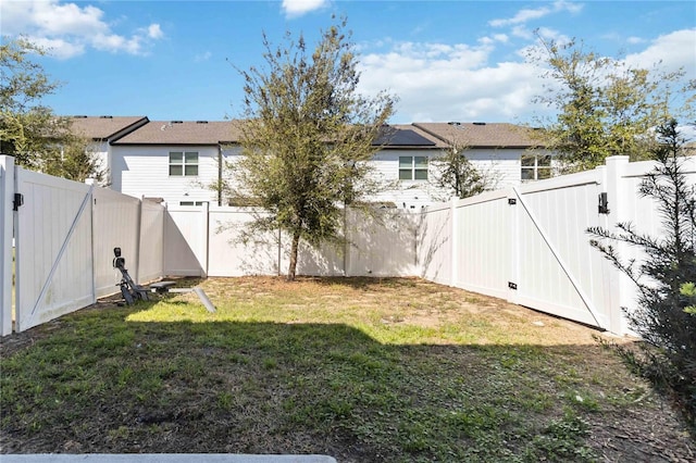 view of yard featuring a gate and a fenced backyard