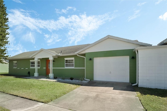 ranch-style house featuring concrete driveway, a garage, and a front yard