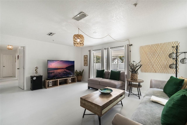 living room featuring visible vents and a textured ceiling