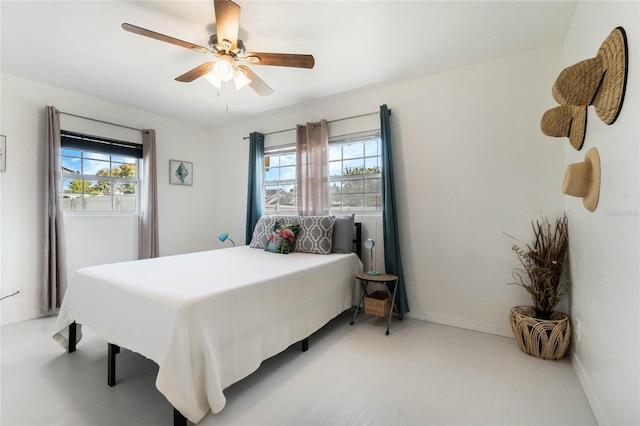 bedroom featuring baseboards and ceiling fan