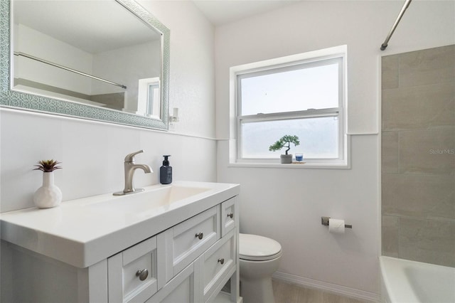 bathroom featuring baseboards, toilet, bathing tub / shower combination, wood finished floors, and vanity