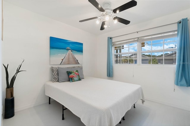 bedroom featuring a ceiling fan and baseboards