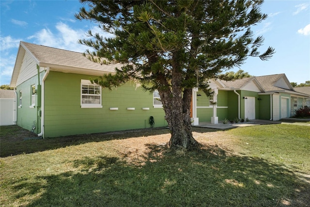 view of home's exterior with a lawn and a garage