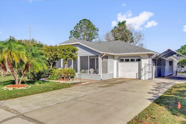 view of front facade with stucco siding, driveway, a shingled roof, a sunroom, and a garage