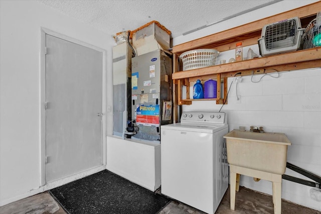 laundry room with laundry area, heating unit, washer / clothes dryer, a textured ceiling, and concrete block wall