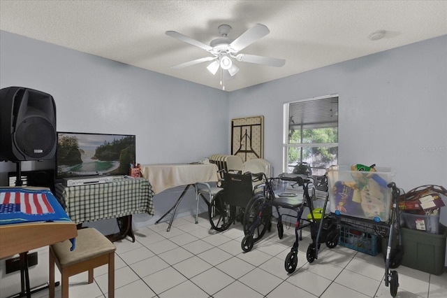 playroom featuring light tile patterned floors, a ceiling fan, and a textured ceiling