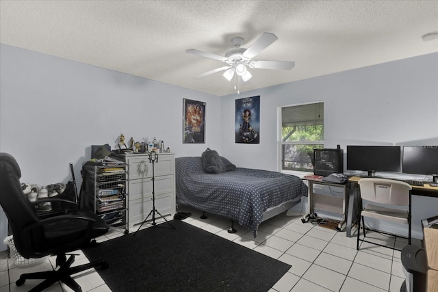 bedroom featuring ceiling fan, light tile patterned floors, and a textured ceiling