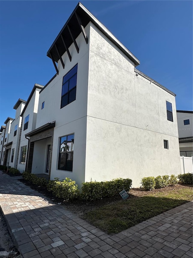 view of side of property with stucco siding